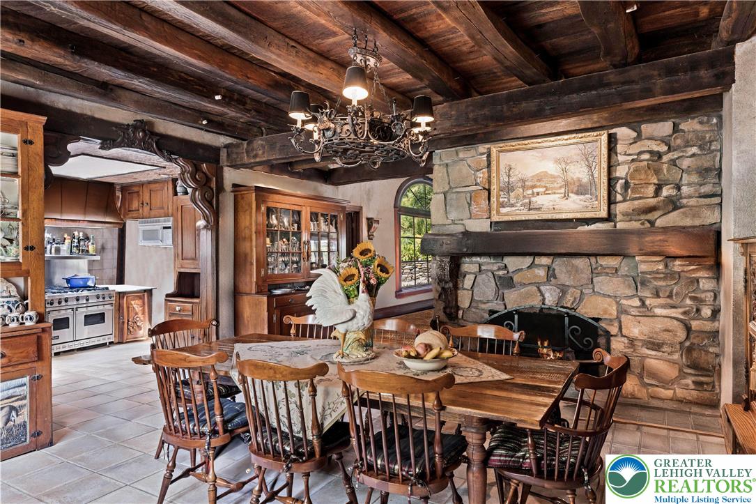 3791 Hunter Road Kintnersville, PA 18930 - Photo 15 of 55 a view of a dining room with furniture a chandelier and fireplace