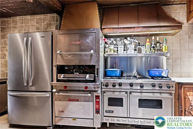 a kitchen with stainless steel appliances granite countertop a refrigerator and a sink