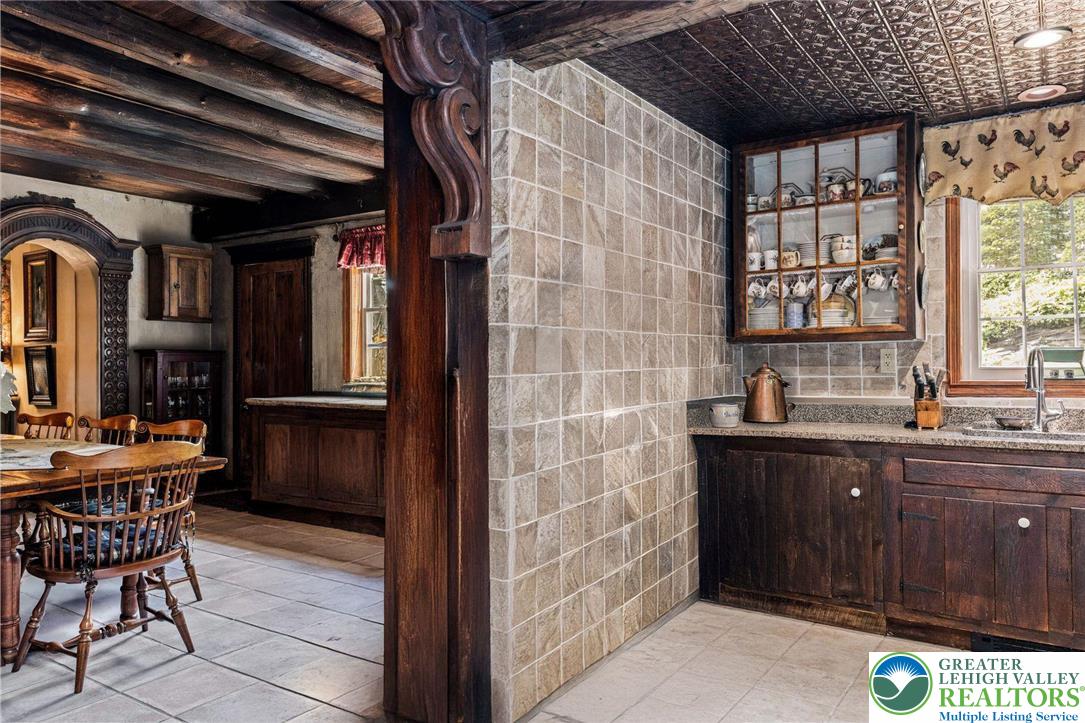 3791 Hunter Road Kintnersville, PA 18930 - Photo 18 of 55 a kitchen with a sink a refrigerator and wooden cabinets