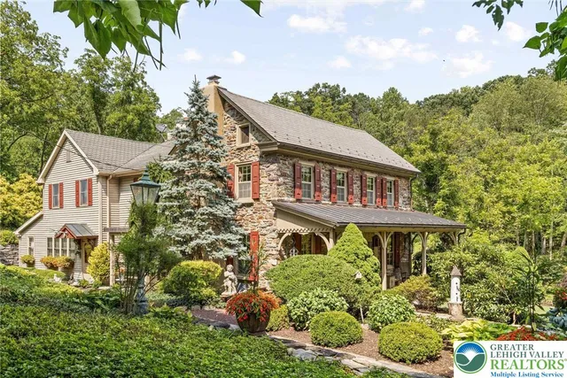 a aerial view of a house with a yard and potted plants