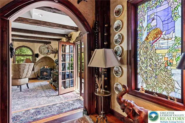 a bedroom with a bed a dresser with chair and window