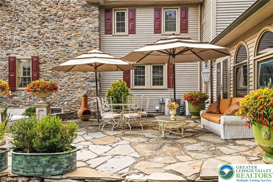 3791 Hunter Road Kintnersville, PA 18930 - Photo 23 of 55 a patio with a table and chairs under an umbrella