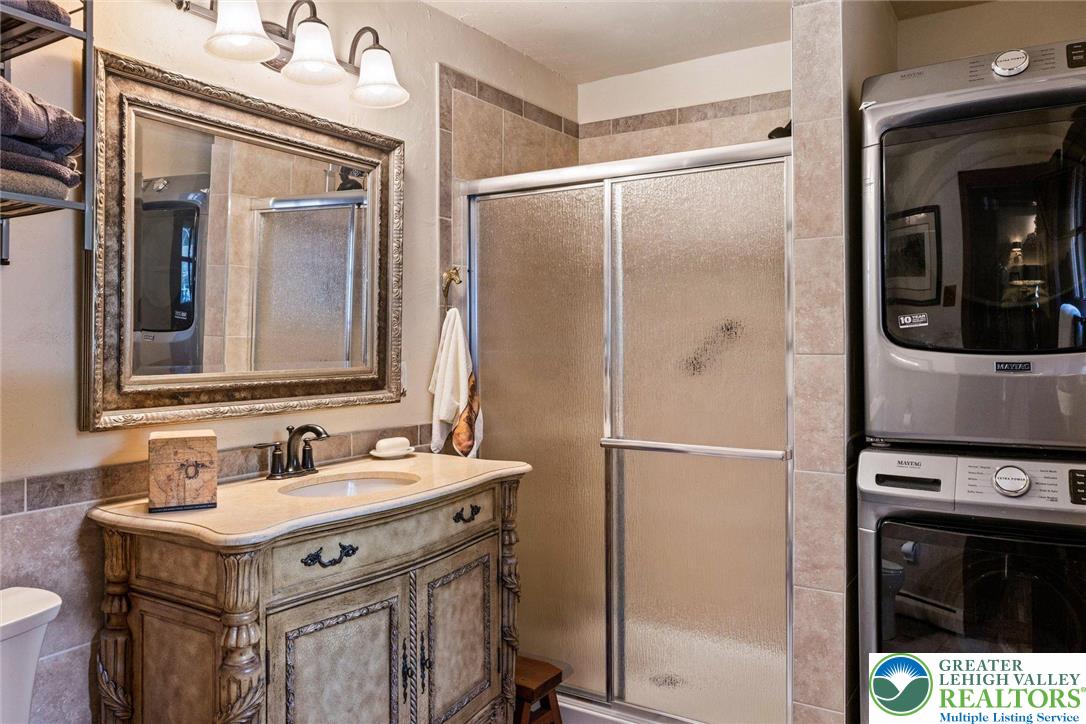3791 Hunter Road Kintnersville, PA 18930 - Photo 27 of 55 a bathroom with a sink a mirror a vanity and a shower