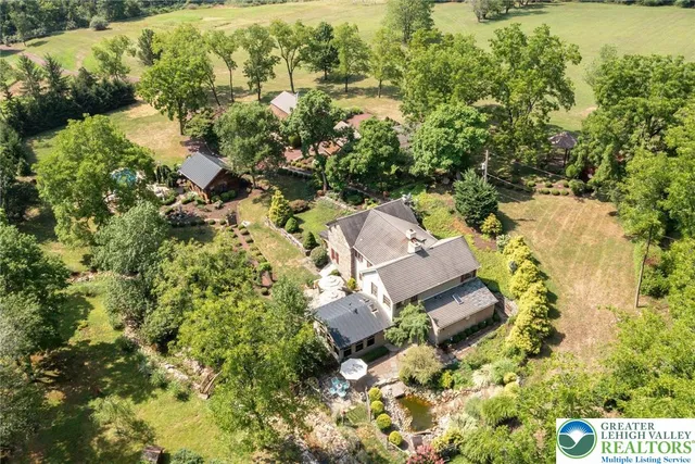an aerial view of a house with a yard