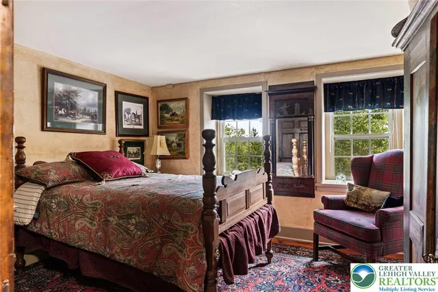 a living room with furniture a fireplace and a chandelier
