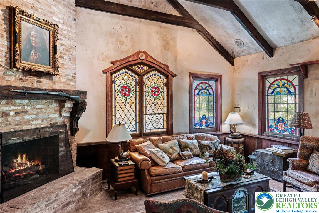 3791 Hunter Road Kintnersville, PA 18930 - Photo 40 of 55 a living room with furniture a fireplace and a window