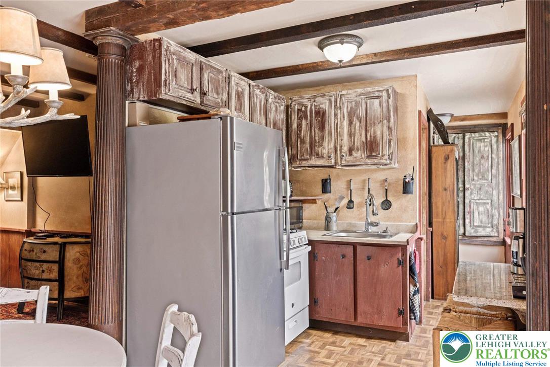 3791 Hunter Road Kintnersville, PA 18930 - Photo 46 of 55 a kitchen with stainless steel appliances granite countertop a refrigerator a sink and a stove