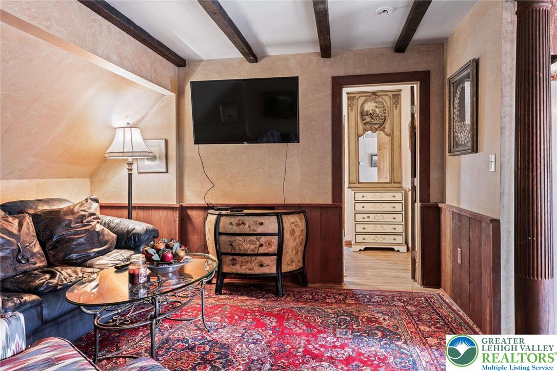 3791 Hunter Road Kintnersville, PA 18930 - Photo 48 of 55 a living room with furniture a flat screen tv and kitchen view