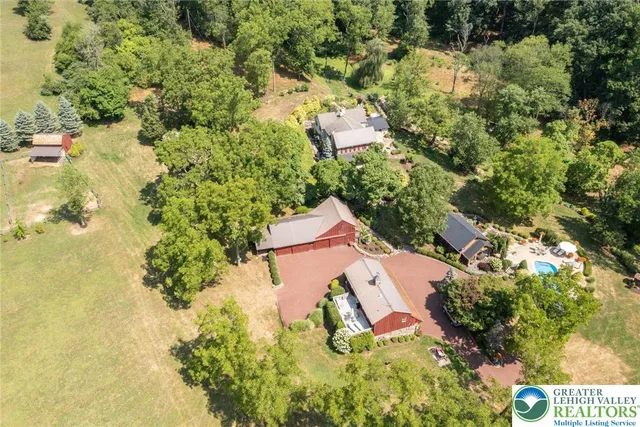 an aerial view of residential houses with yard