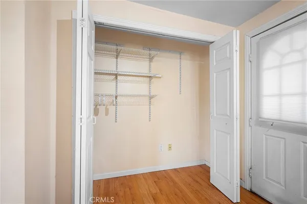 a view of a room with wooden floor and closet