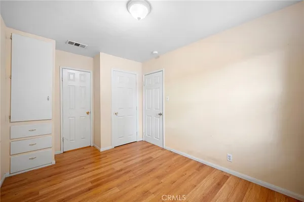 a view of a room with wooden floor
