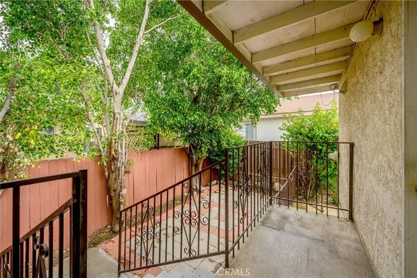 a view of balcony with wooden floor and fence