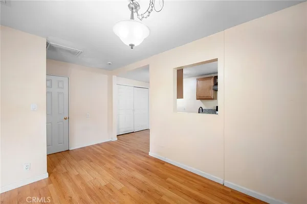 a view of a room with wooden floor and ceiling fan