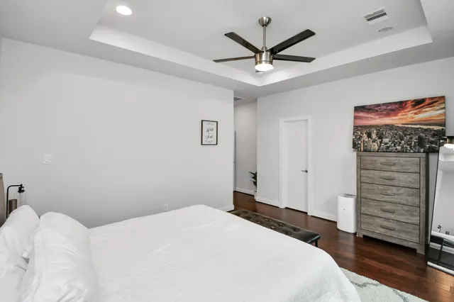 a bedroom with a bed and a ceiling fan