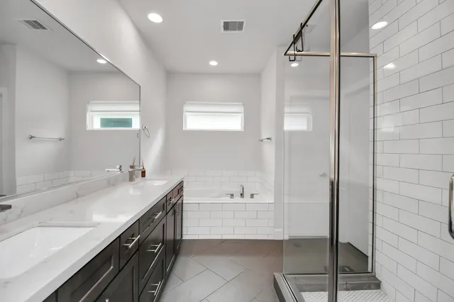 a bathroom with a tub sink and mirror