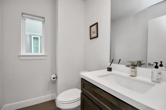 a bathroom with a sink toilet and vanity