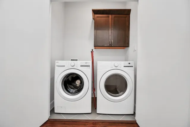 a utility room with sink dryer and washer