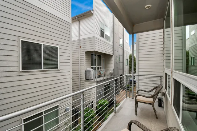 a view of a balcony with chairs