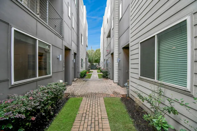 a view of a pathway both side of house