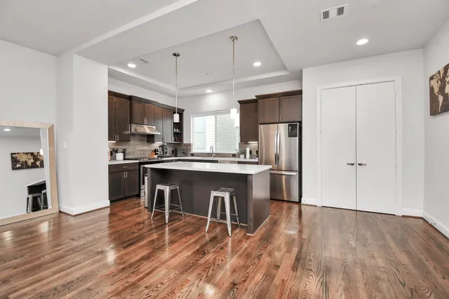 a kitchen with stainless steel appliances a refrigerator stove microwave and cabinets