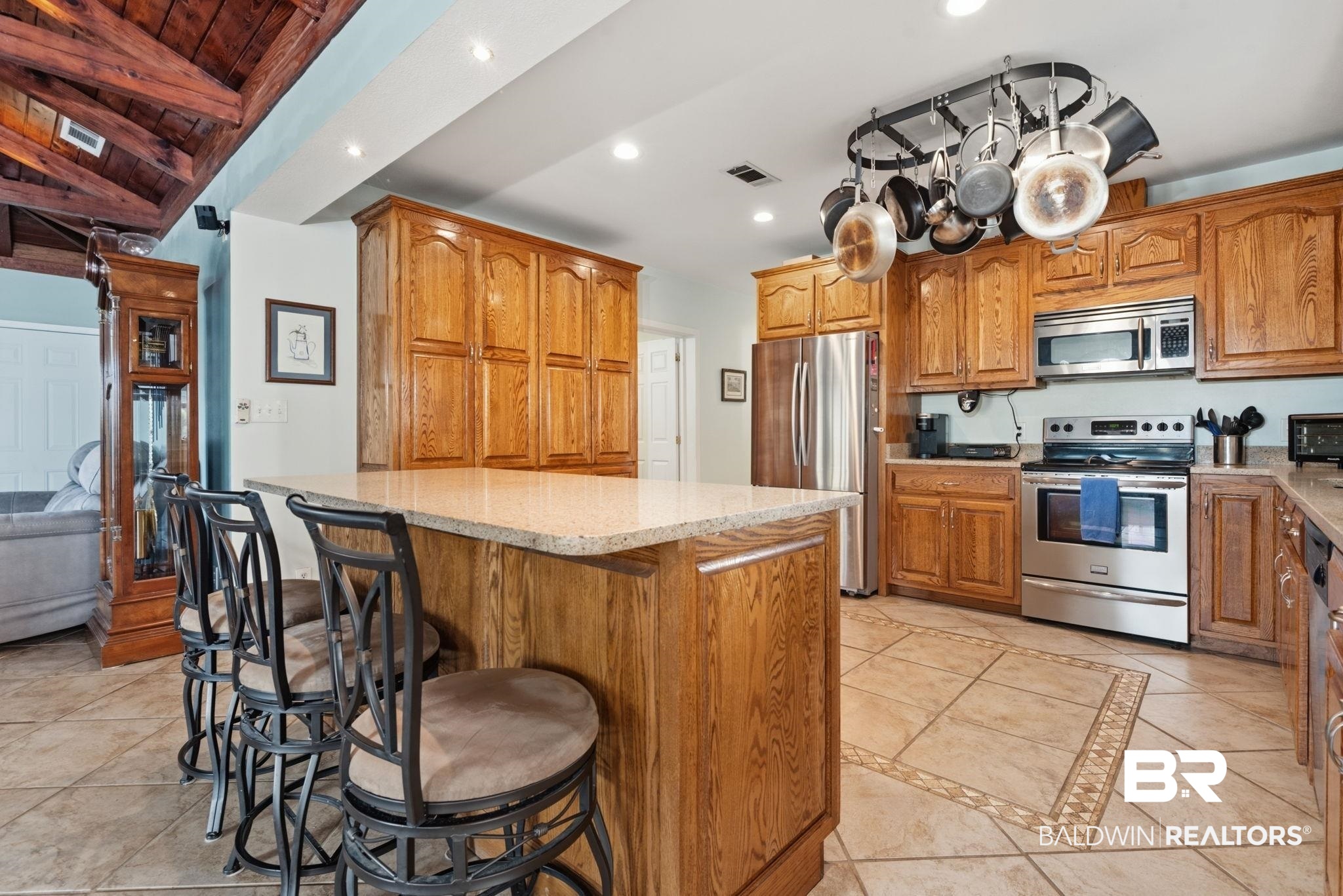 15025 Bellingrath Road Coden, AL 36523 - Photo 44 of 79 Kitchen with a kitchen bar, stainless steel appliances, wood finish cabinets, recessed lighting, and a kitchen island
