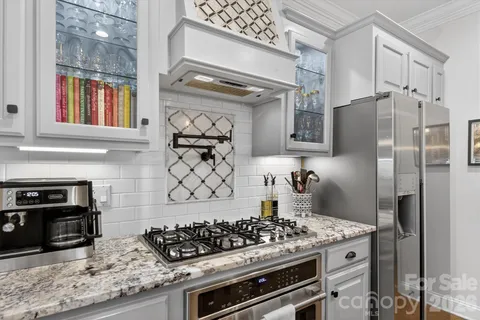 a kitchen with stainless steel appliances granite countertop a stove and a refrigerator