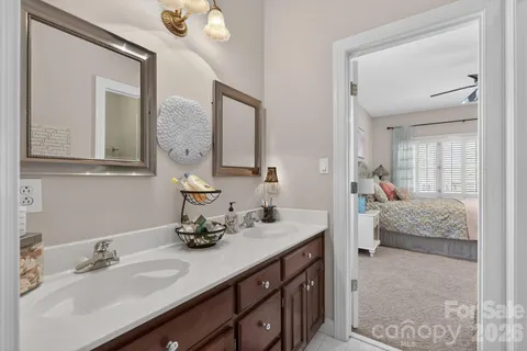 a en suite bathroom with double sink and a mirror