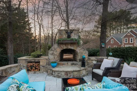 a view of a patio with couches table and chairs and potted plants