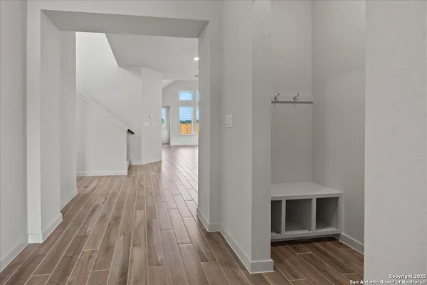 a view of hallway with wooden floor