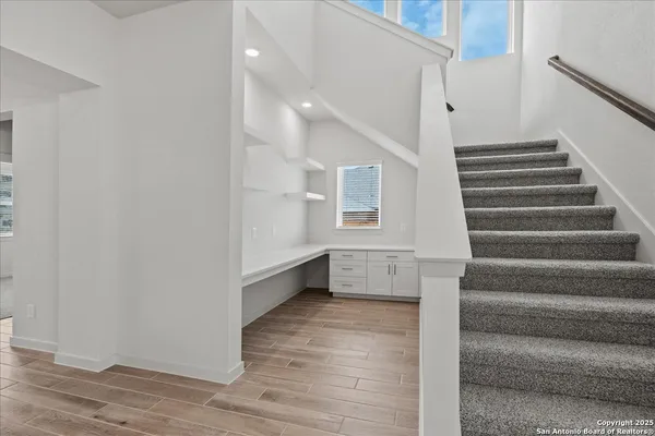 a view of entryway and hall with wooden floor
