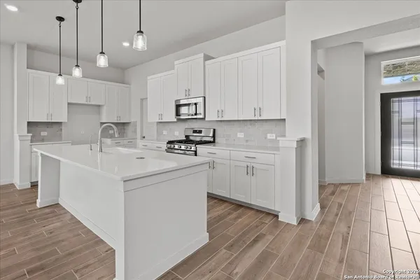 an empty room with a window and a ceiling fan