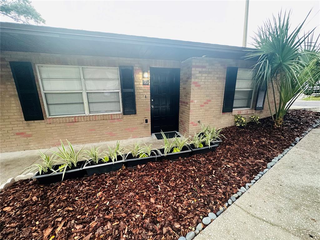 101 Lake Hunter Drive, Unit 15 Lakeland, FL 33803 - Photo 2 of 11 a front view of a house with a yard