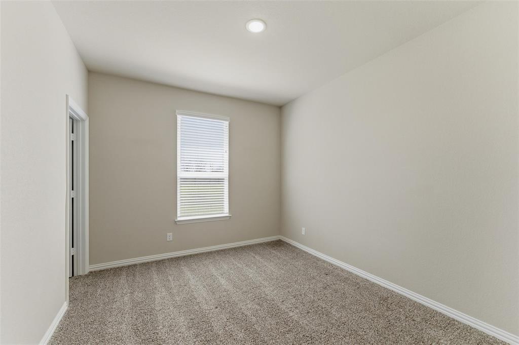 7437 Aniston Way Godley, TX 76044 - Photo 13 of 23 an empty room with a window