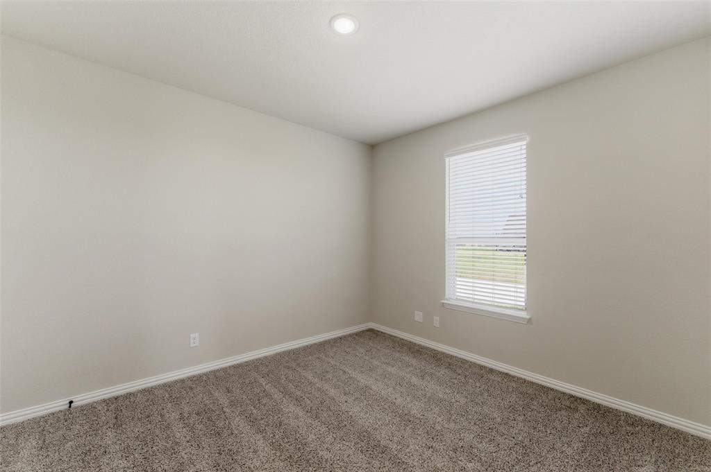 7437 Aniston Way Godley, TX 76044 - Photo 14 of 23 an empty room with a window