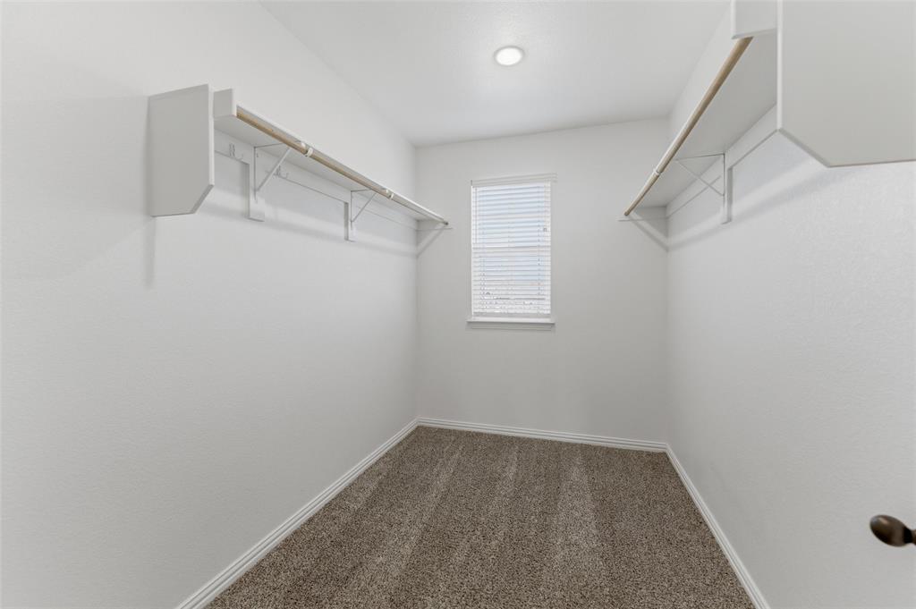 7437 Aniston Way Godley, TX 76044 - Photo 15 of 23 a view of a room with racks on the wall