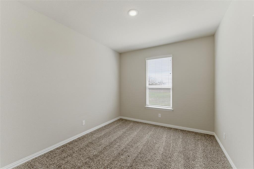 7437 Aniston Way Godley, TX 76044 - Photo 16 of 23 an empty room with a window