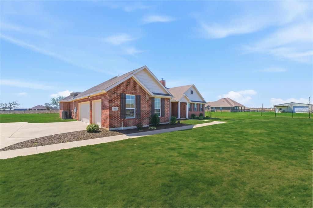 7437 Aniston Way Godley, TX 76044 - Photo 2 of 23 a front view of a house with garden