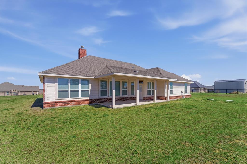 7437 Aniston Way Godley, TX 76044 - Photo 23 of 23 a view of a house with a big yard and large trees