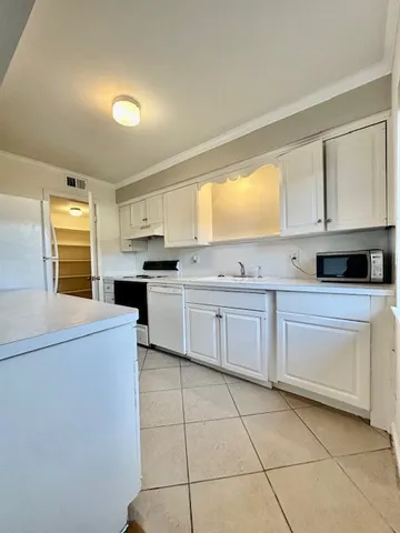 a kitchen with a stove a sink and a refrigerator