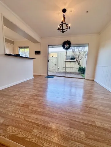 a view of a livingroom with wooden floor and a ceiling fan