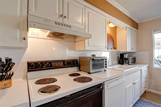 a kitchen with a sink a window and cabinets