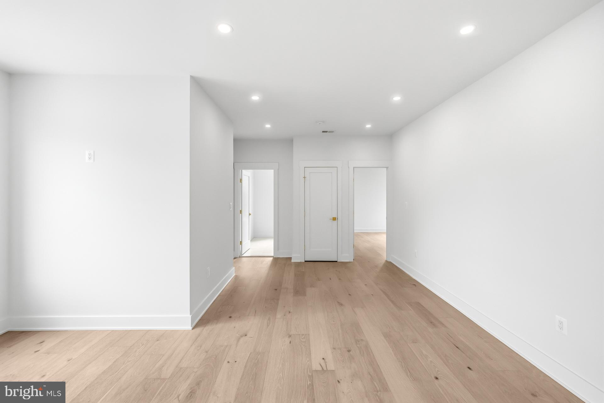 719 Meadow Lane Southwest Vienna, VA 22180 - Photo 32 of 118 an empty room with wooden floor and natural light