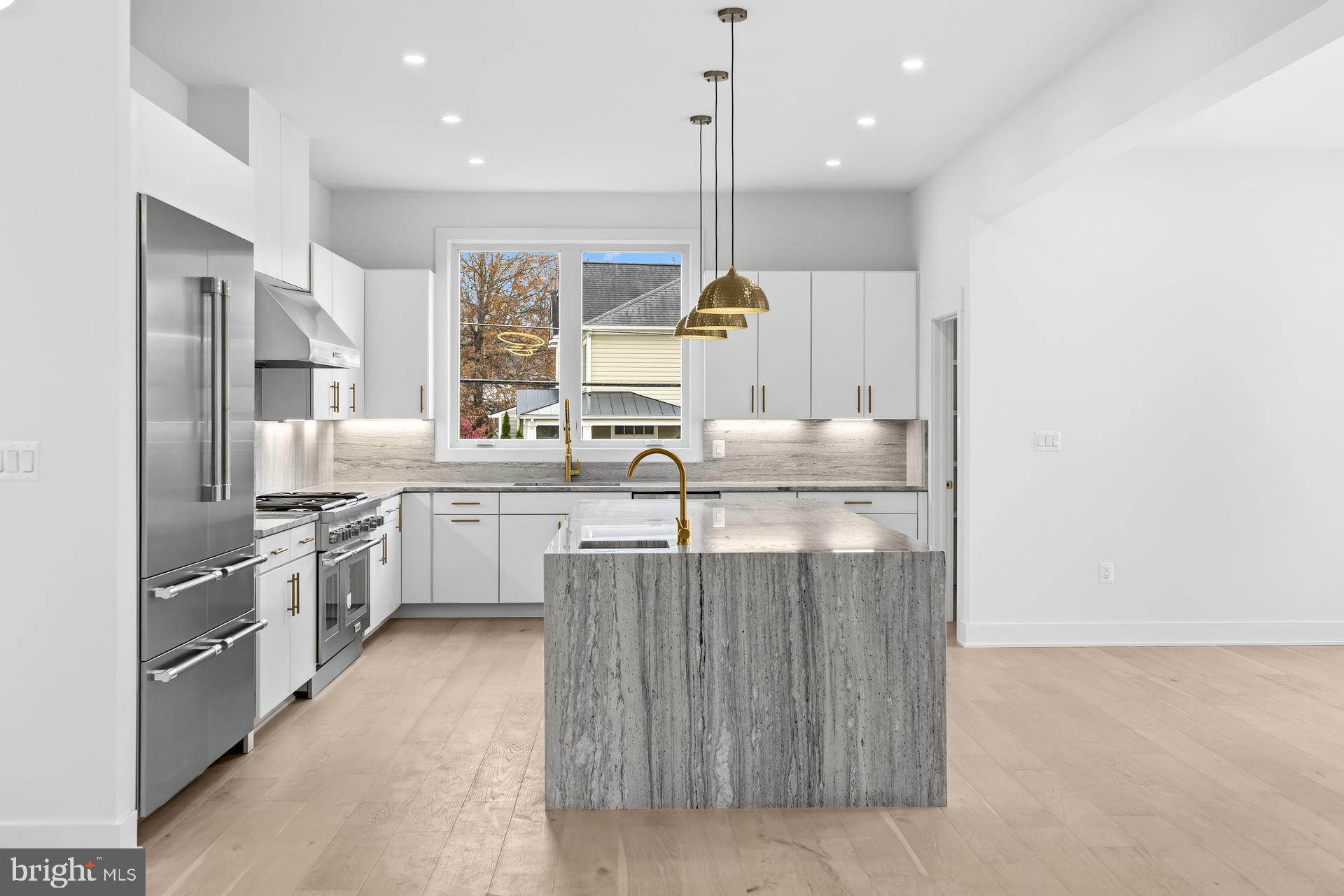 719 Meadow Lane Southwest Vienna, VA 22180 - Photo 5 of 118 a kitchen with stainless steel appliances granite countertop a sink a stove and a refrigerator