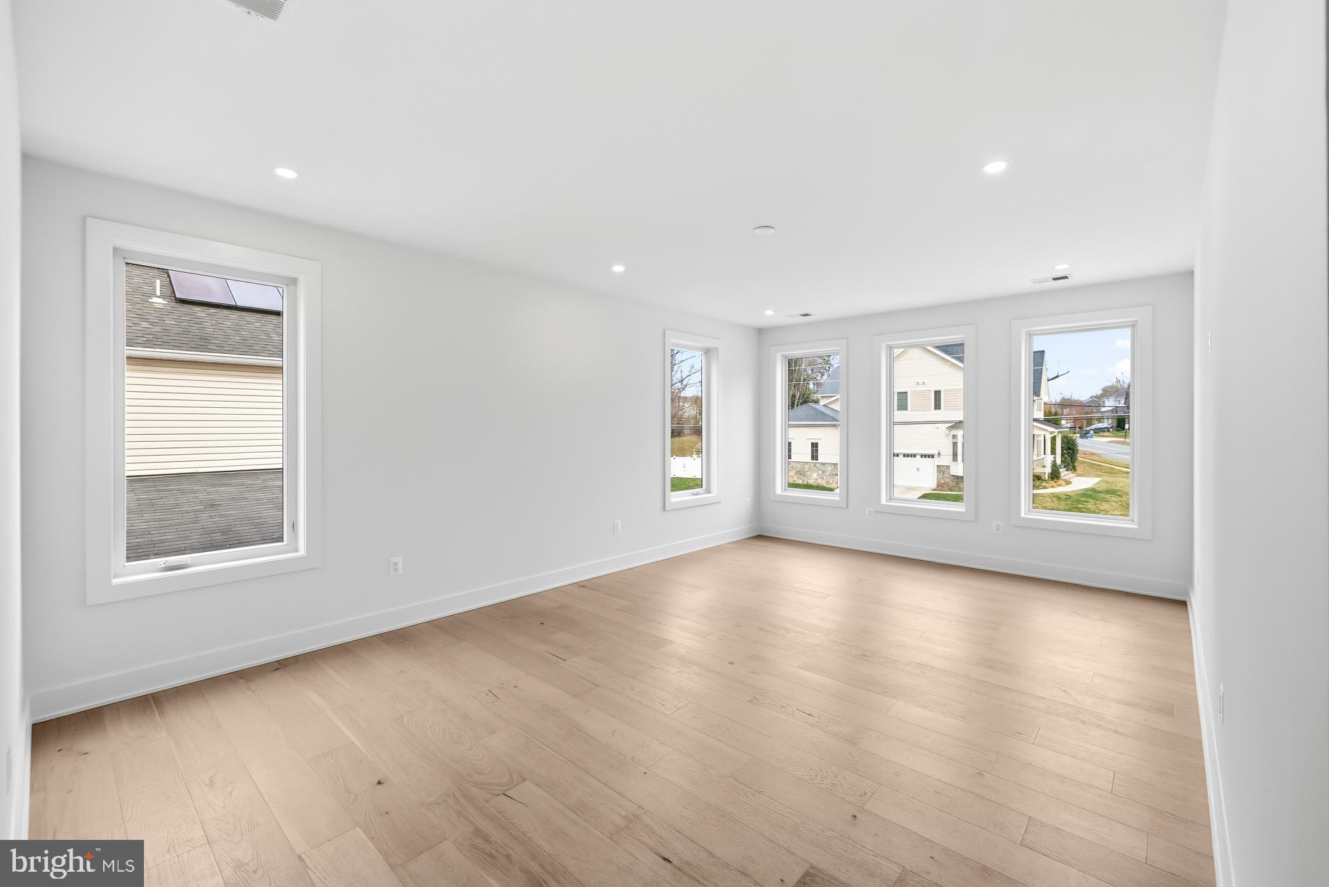 719 Meadow Lane Southwest Vienna, VA 22180 - Photo 51 of 118 an empty room with window and wooden floor