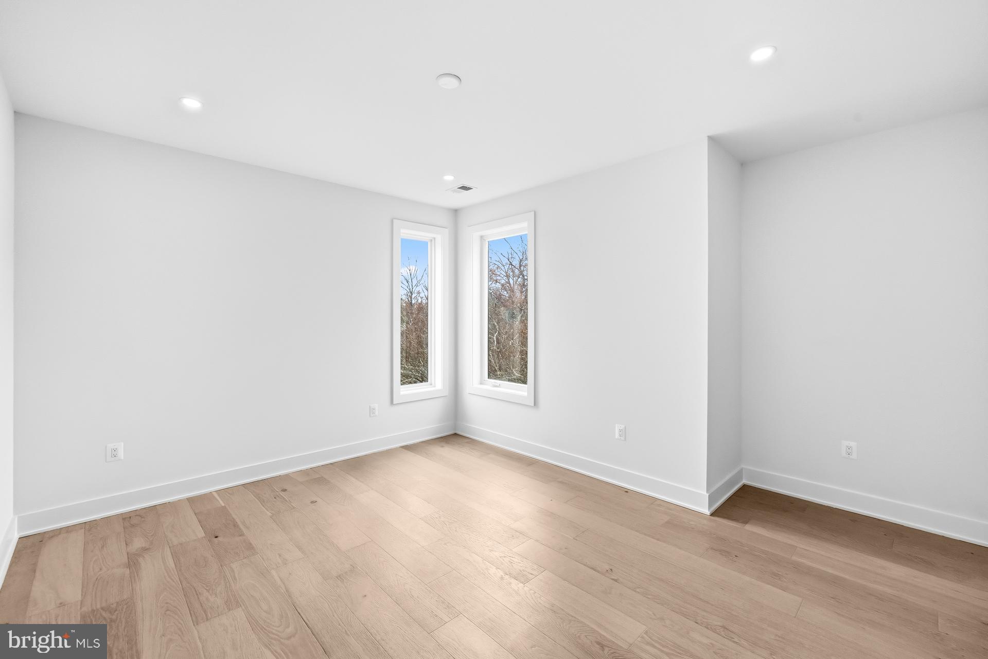 719 Meadow Lane Southwest Vienna, VA 22180 - Photo 63 of 118 an empty room with wooden floor and windows