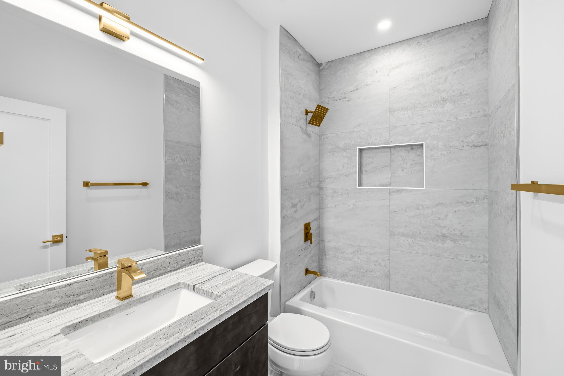 719 Meadow Lane Southwest Vienna, VA 22180 - Photo 90 of 118 a bathroom with a granite countertop sink mirror toilet and bathtub