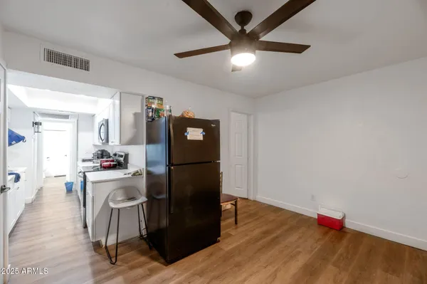 a kitchen with a refrigerator and a stove