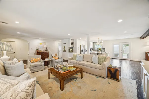 a living room with furniture or kitchen view and a wooden floor
