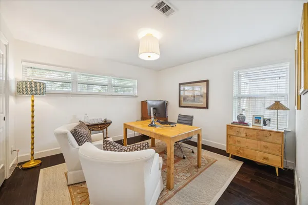 a view of a dining room with furniture and a window