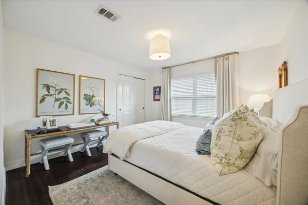 a bedroom with a bed and a table in it